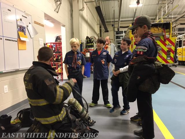 Lt. Dan Sheridan demonstrating an air pack and equipment to visiting cub scouts.